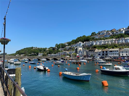 Looe river full of boats with a view of East Looe beyond